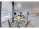 Bright dining area with modern decor, complemented by natural light and seamless connection to the kitchen and living area at 520 Prestwick Dr, Davenport, FL 33897