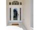 Elegant white front door with sidelights and transom window, creating a welcoming entrance at 520 Prestwick Dr, Davenport, FL 33897