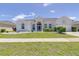 Charming single-story home with a manicured lawn and well-maintained landscaping at 520 Prestwick Dr, Davenport, FL 33897