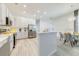 Bright kitchen featuring stainless steel appliances, white cabinets, and an adjacent dining area perfect for casual meals at 520 Prestwick Dr, Davenport, FL 33897