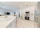 Modern kitchen boasts stainless steel appliances, ample countertop space, and sleek white cabinets for a clean look at 520 Prestwick Dr, Davenport, FL 33897