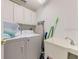 Functional laundry room featuring a washer, dryer, utility sink, and ample storage space for all your laundry needs at 520 Prestwick Dr, Davenport, FL 33897
