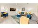 Cozy living room showcasing stylish decor, including a plush blue armchair and a decorative accent wall at 520 Prestwick Dr, Davenport, FL 33897