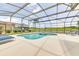 Relax by the pool and spa in this screened-in lanai, perfect for entertaining and enjoying the Florida lifestyle at 520 Prestwick Dr, Davenport, FL 33897