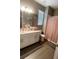 Bathroom with a double sink vanity, large mirror, and a separate toilet and shower area at 5306 Meadow Song Dr, Okahumpka, FL 34762