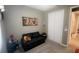 Cozy bedroom featuring a futon, neutral walls, and closet at 5306 Meadow Song Dr, Okahumpka, FL 34762