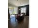 Bright dining room features hardwood floors and a sliding glass door to a patio at 5306 Meadow Song Dr, Okahumpka, FL 34762