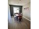 Dining room with wood floors, a chandelier, and coffee-themed wall art at 5306 Meadow Song Dr, Okahumpka, FL 34762