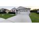 Beautiful single-Gathering home with a wide driveway, stone accents, and holiday decorations at 5306 Meadow Song Dr, Okahumpka, FL 34762