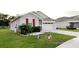 Charming single-Gathering home with stone accents, well-manicured lawn and red shutters at 5306 Meadow Song Dr, Okahumpka, FL 34762