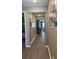Hallway with hardwood floors and neutral paint, offering a view of the rooms at 5306 Meadow Song Dr, Okahumpka, FL 34762