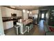 Kitchen with modern cabinets, stainless appliances, pendant lights and an eat-in island at 5306 Meadow Song Dr, Okahumpka, FL 34762