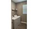 Laundry room with a side-by-side washer and dryer, storage shelf, and a window at 5306 Meadow Song Dr, Okahumpka, FL 34762