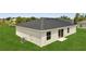 Rear exterior view of a well-maintained home, green yard, and sliding glass doors at 563 Viceroy Ct, Kissimmee, FL 34758