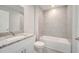 Modern bathroom with a stylish vanity, granite countertop, and a tub-shower combination at 563 Viceroy Ct, Kissimmee, FL 34758