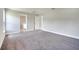 Large primary bedroom with neutral gray paint, gray carpet and walk in closet at 563 Viceroy Ct, Kissimmee, FL 34758