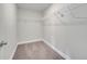 An organized walk-in closet with wire shelving to optimize storage and organization at 563 Viceroy Ct, Kissimmee, FL 34758