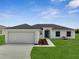 Charming single-story home with a well-manicured lawn and a two-car garage at 563 Viceroy Ct, Kissimmee, FL 34758