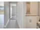 Hallway view of an open-concept home, connecting the living spaces to bathroom at 563 Viceroy Ct, Kissimmee, FL 34758