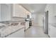 Bright kitchen features white cabinets, stainless steel appliances and granite countertops at 563 Viceroy Ct, Kissimmee, FL 34758