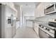 Modern kitchen with stainless steel appliances and white cabinetry at 563 Viceroy Ct, Kissimmee, FL 34758