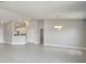 Neutral living room leading into the kitchen with tile floors and modern recessed lighting at 563 Viceroy Ct, Kissimmee, FL 34758