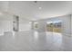 Expansive living room with backyard views through a sliding glass door, enhanced by neutral walls and tile flooring at 563 Viceroy Ct, Kissimmee, FL 34758