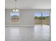 An open-concept living space with tile flooring and a sliding glass door with a view of the backyard at 563 Viceroy Ct, Kissimmee, FL 34758