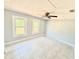 Bright bedroom featuring neutral paint, tile flooring, and a ceiling fan with two windows providing ample natural light at 6100 Skokie Rd, Lake Wales, FL 33898