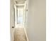 Hallway with tiled floors and neutral walls, creating a seamless flow to the living spaces at 6100 Skokie Rd, Lake Wales, FL 33898