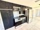 Functional kitchen featuring modern appliances and dark cabinetry, blending style and convenience at 6100 Skokie Rd, Lake Wales, FL 33898