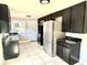 Bright kitchen with stainless steel appliances, ample cabinetry, and tiled flooring at 6100 Skokie Rd, Lake Wales, FL 33898