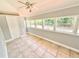 Cozy sunroom with tile flooring and multiple windows offering serene outdoor views at 6100 Skokie Rd, Lake Wales, FL 33898