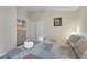 Bedroom with double closet, dresser, television and cozy bed with neutral colored walls at 620 Old Bridge Cir, Davenport, FL 33897