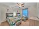 Cheerful room with twin beds, dinosaur-themed bedding, and fun cartoon wall decals at 620 Old Bridge Cir, Davenport, FL 33897