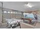 Bright game room featuring a pool table, air hockey table, beach mural and attached garage at 620 Old Bridge Cir, Davenport, FL 33897