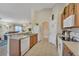Functional kitchen with pantry, white appliances, and view to the living room at 620 Old Bridge Cir, Davenport, FL 33897