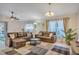 Spacious living room featuring plush sofas, stylish decor, and plenty of natural light at 620 Old Bridge Cir, Davenport, FL 33897
