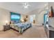 Spacious main bedroom featuring ensuite bathroom, television, ceiling fan and bright, natural light at 620 Old Bridge Cir, Davenport, FL 33897