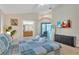 Comfortable main bedroom with ensuite bathroom, television, and a view of the pool at 620 Old Bridge Cir, Davenport, FL 33897