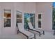 Outdoor patio area with two lounge chairs, with access to a screened-in lanai and a view of the backyard at 620 Old Bridge Cir, Davenport, FL 33897