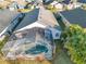 Aerial of screened in pool and backyard, lush greenery, great for outdoor entertaining at 620 Old Bridge Cir, Davenport, FL 33897