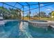 Inviting screened pool and spa with sunlit backyard, perfect for relaxation and entertaining at 620 Old Bridge Cir, Davenport, FL 33897