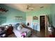 Bright bedroom featuring calming paint, ceiling fan, and a comfortable bed at 6480 Fall St, St Cloud, FL 34771