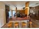 Kitchen with wooden cabinets, bar seating, and stainless steel appliances at 6480 Fall St, St Cloud, FL 34771