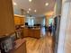 View of an open-concept kitchen with stainless steel appliances and wood floors at 6480 Fall St, St Cloud, FL 34771