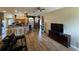 Open-concept living area with wood floors, a sofa, and views of the kitchen at 6480 Fall St, St Cloud, FL 34771