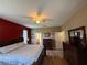 Main bedroom with hardwood flooring, ceiling fan, and en suite bathroom at 6480 Fall St, St Cloud, FL 34771