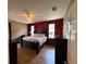 Spacious main bedroom with hardwood floors, a ceiling fan, and natural light at 6480 Fall St, St Cloud, FL 34771