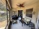 Relaxing screened patio with seating, a ceiling fan, and a grill at 6480 Fall St, St Cloud, FL 34771